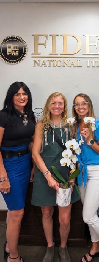 Paige Slawson at closing with clients &mdash; Flat Five Realty Grand Junction